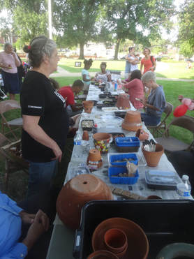 community members ceating mosaic pots 